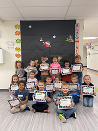 Group of children with read-a-thon certificates