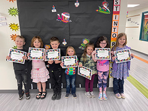 Children holding read-a-thon certificates