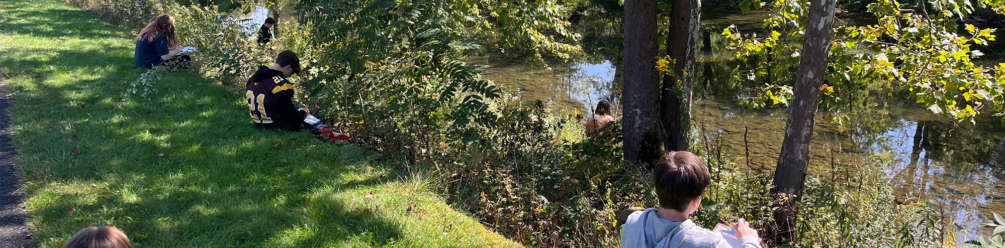 Students by a creek
