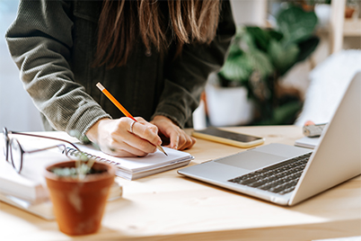 student on a computer writing