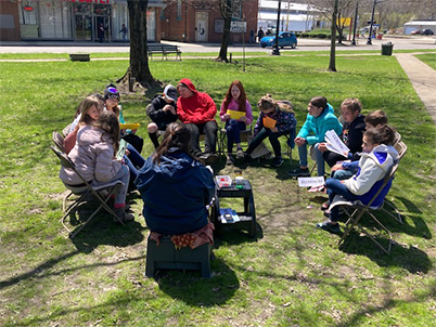 Students outside in a circle