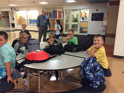 Mr. Ledebur, School Counselor, greets students the first day of school.