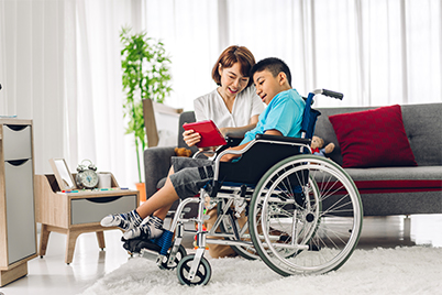 Parent talking to son in wheelchair