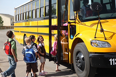 students getting on the bus